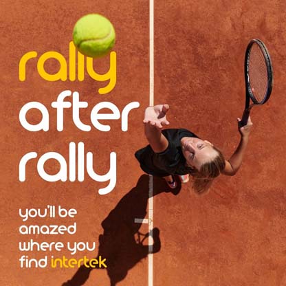 A player tossing a tennis ball into the air with his racket positioned to hit it